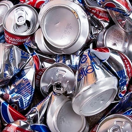 Photo shows a stack of used cans